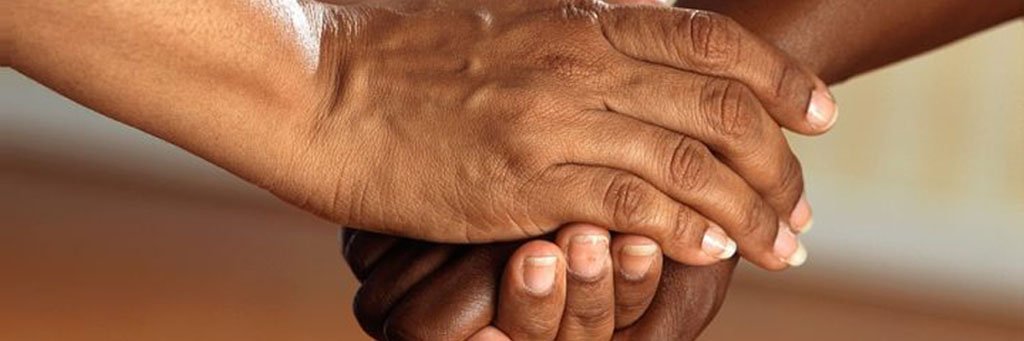 two hands with a gesture that looks like Humanitarian and Compassionate